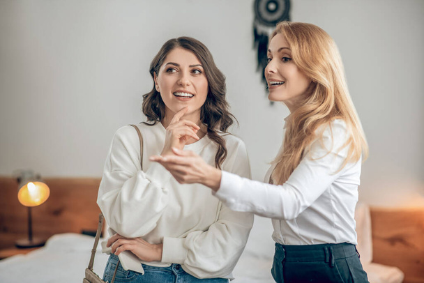 Young woman talking with a real estate agent about renting an apartment and looking involved - Φωτογραφία, εικόνα