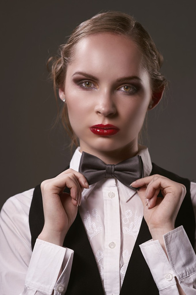 Woman dressed in suit and bow tie - Fotó, kép