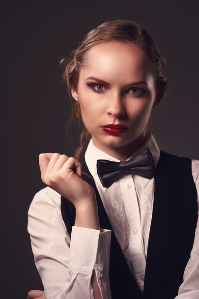 Woman dressed in suit and bow tie - Zdjęcie, obraz