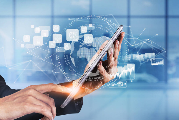 Businesswoman wearing formal suit is touching a tablet with digital interface with globe, cloud data, padlock, coin icons. Blurred office in background. Concept of international business and network - Foto, Imagem