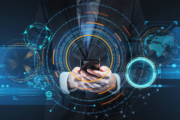 Businessman wearing formal suit is holding smartphone with digital interface hologram in his hand. Hud with globe and padlock icons in the foreground. Concept of future technologies and data security - Zdjęcie, obraz