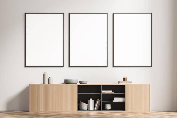 Row of three mockup posters on the light beige wall of the waiting room area. Modern house design, using wood material for sideboard and parquet floor. Minimalist concept. 3d rendering. - Foto, Imagem