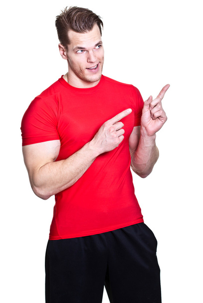 jeune homme athlétique pointant quelque chose - isolé sur le coup de fouet
 - Photo, image