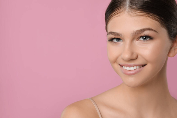 Pretty girl on pink background, space for text. Beautiful face with perfect smooth skin - Fotoğraf, Görsel