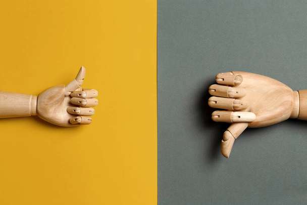 Wooden mannequin hands on color background, flat lay - Фото, изображение