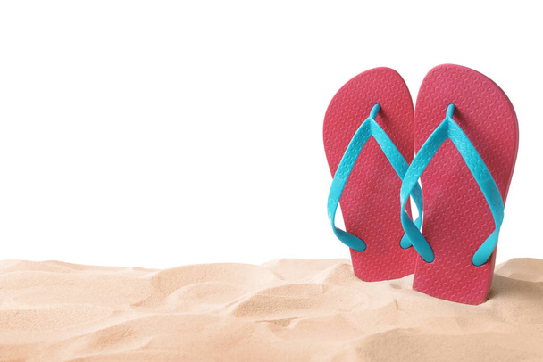 Pink flip flops in sand on white background - Foto, Imagem