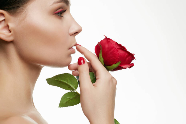Piękna młoda kobieta z kwiatem. Zmysłowy Portret Piękności Dziewczyny Z Kwiatu Róży. Czysta twarz, makijaż, manicure, pielęgnacja - Zdjęcie, obraz