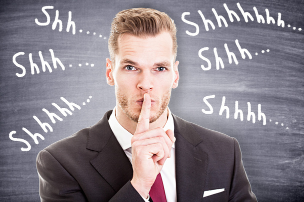 Бизнесмен с пальцем на губах просит молчание
 - Фото, изображение