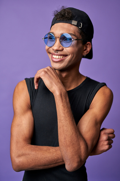 Portrait of cheerful transgender male in black t-shirt, blue sunglasses. Latin american trans gender - Фото, зображення