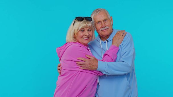 Cheerful lovely senior couple man woman grandparents smiling hugging enjoying lifestyle together - Photo, Image