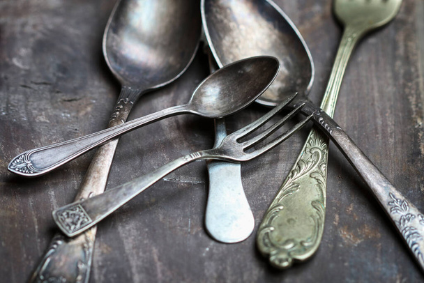 Vintage cutlery on a wooden table. Graphic resources - Photo, image