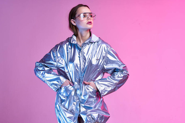 pretty woman silvery jacket fashion posing nightclub pink background - Фото, изображение