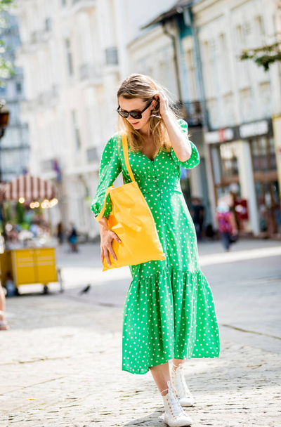 Young beautyful woman with yellow linen eco bag on city background. - Valokuva, kuva