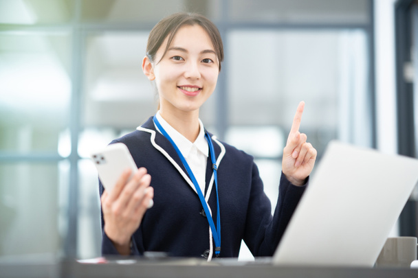 Asian woman posing with her index finger in the office - Photo, Image