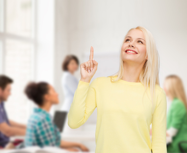 smiling woman pointing her finger up - Photo, Image