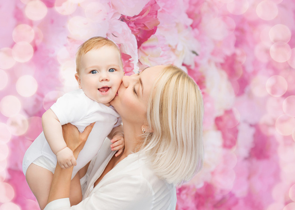happy mother kissing smiling baby - 写真・画像