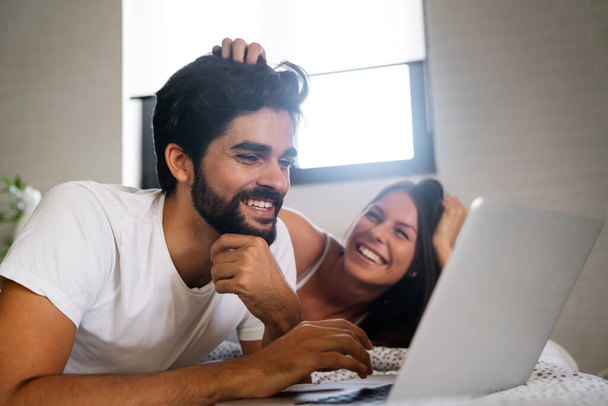 Romantic young happy couple in love relaxing at home having fun, watching movie. People technology concept. - Foto, imagen