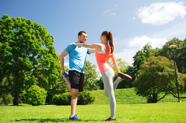 smiling couple stretching outdoors - Foto, immagini