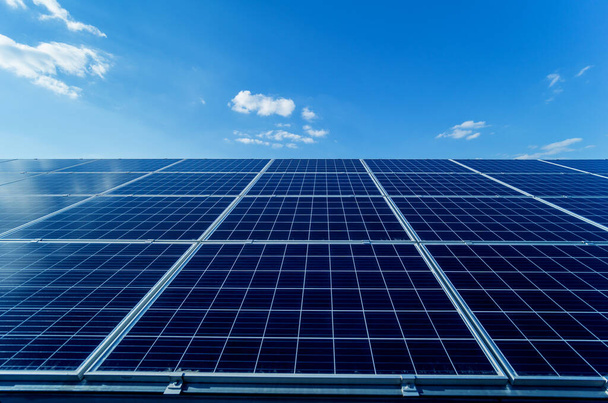 Photovoltaic solar panels on blue sky background - Foto, imagen