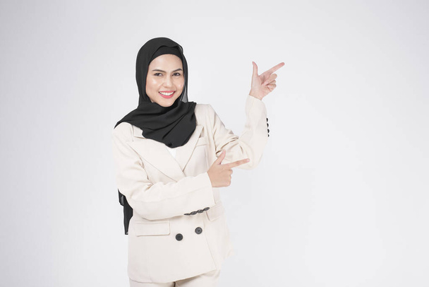 Portrait of young smiling muslim businesswoman wearing suit with hijab over white background studio.	 - Φωτογραφία, εικόνα