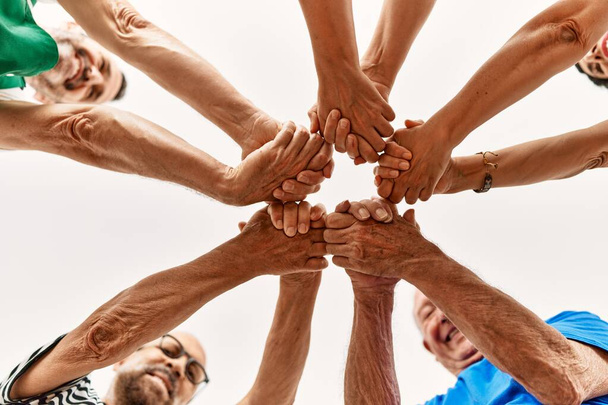 Group of middle age friends with hands together. - Photo, Image