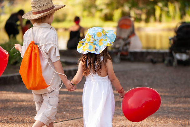 Little girl and boy with balloons in the park - Photo, image