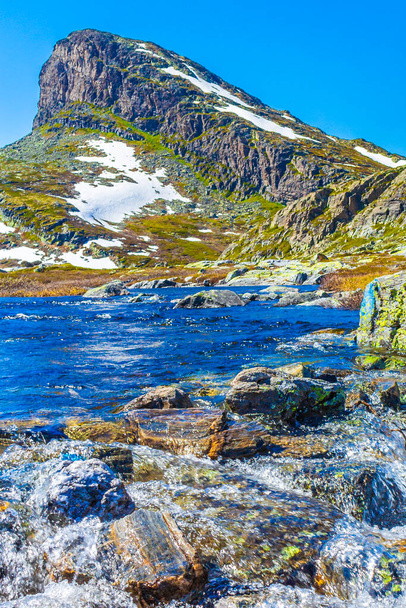 Amazing Storehodn mountain peak river and snow in summer at Veslehodn mountain by the Hydnefossen waterfall in Hemsedal Norway. - Photo, image