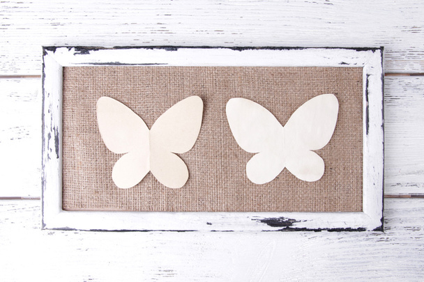 Wooden frame with paper butterflies isolated on white - Fotografie, Obrázek
