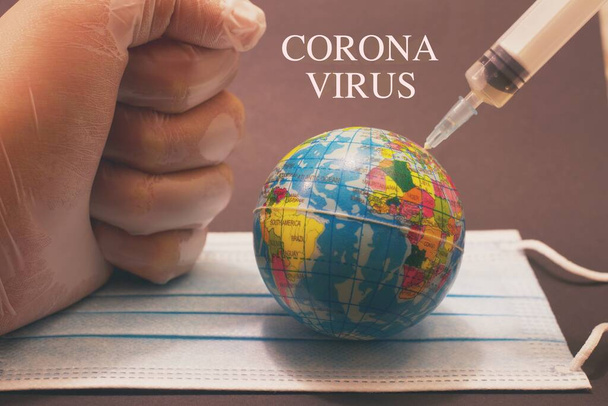 Naald van een spuit, geschoten in de hele wereld, concept van wereldwijde vaccinatie tegen het Coronavirus. - Foto, afbeelding