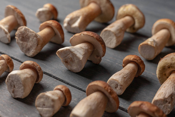 Porcini or white mushrooms on wooden table. Close up. - Zdjęcie, obraz