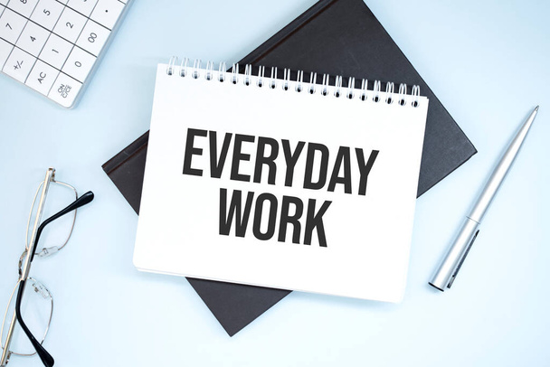 Writing text showing everyday work. Calculator,pen,plan,glasses and black folder on grey background - Zdjęcie, obraz