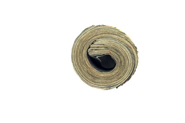 us money rolled up with a rubber band isolated on white. the most popular money. - Foto, Imagen