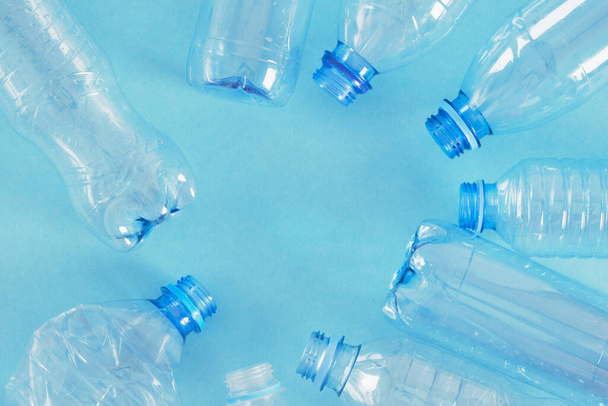 several plastic bottles on blue background. zero waste, pollution of nature, eco friendly concept. copy space plastic bottle frame - Фото, зображення