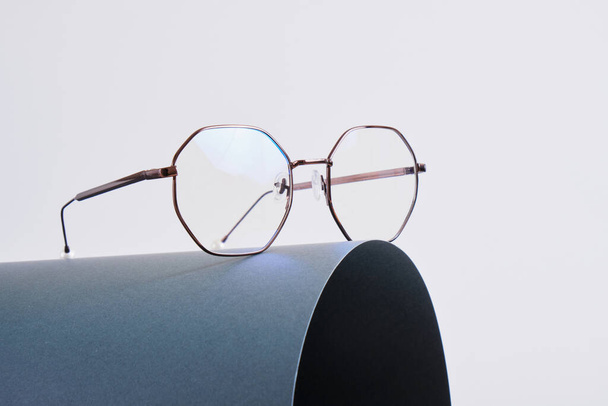 eye glasses on dark gray wrapped paper, trendy fashion glasses on gray background copy space - Fotó, kép