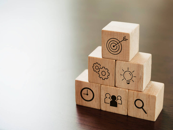 Modern business icons on wooden cube blocks, pyramid steps on desk with copy space. Leadership, key success, business strategy and Action plan concept. - Photo, Image