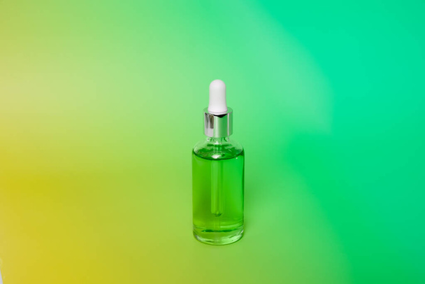 Dropper glass bottles with pipette. Transparent hyaluronic natural beauty mineral product and eco serum skin care concept. Top horizontal view copyspace. Summer juicy colors - Фото, зображення