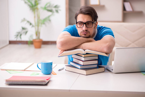 Young male student studying at home - Foto, imagen