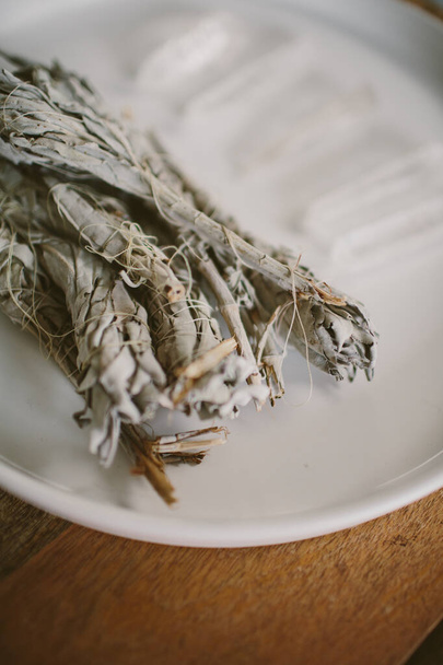 Several crystals and sage for meditation in a white plate - 写真・画像