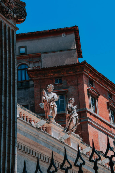 A vertical shot of a statue details in Basilica di San Pietro, Vatican City - Photo, image