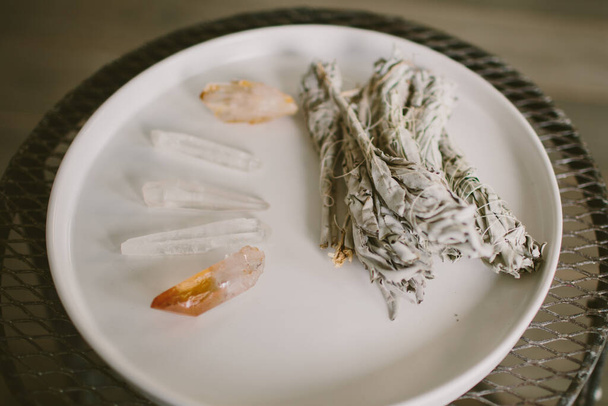 Several crystals and sage for meditation in a white plate - Fotó, kép