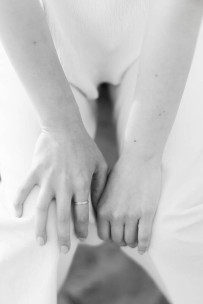 body details, women's hands close-up on natural texture, black and white photo soft focus - Fotografie, Obrázek