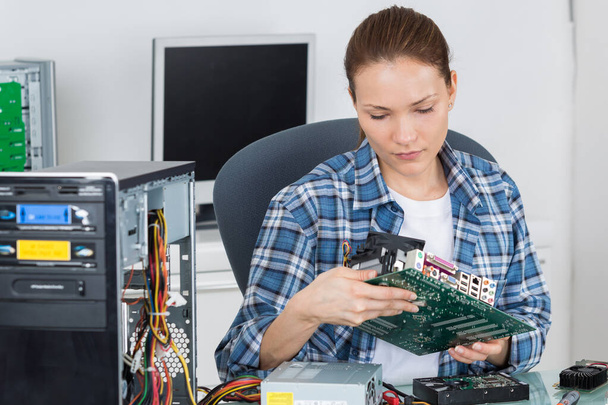 portrait of woman holding computer component - Photo, image