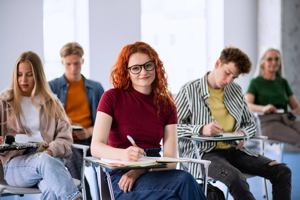 Portrait of group of university students sitting in classroom indoors, studying. - Φωτογραφία, εικόνα