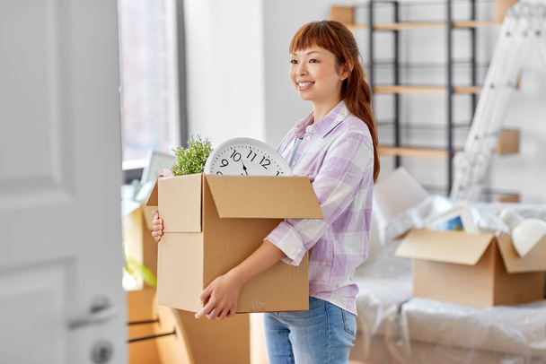 happy woman unpacking boxes and moving to new home - 写真・画像