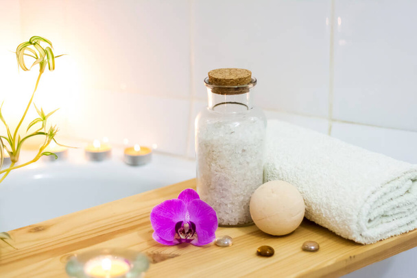 Spa-beauty salon, wellness center. Spa treatment aromatherapy for a woman's body in the bathroom with candles, oils and salt. Lifestyle and cosmetic concept   - Fotó, kép
