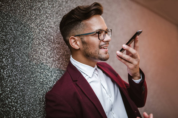 Happy handsome businessman using mobile phone outdoor - Photo, Image