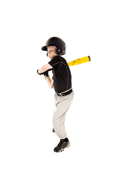 boy baseball player swinging at pitch with his eyes closed - 写真・画像