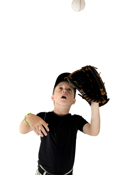 young boy baseball player focused on catching the baseball - Foto, Imagem