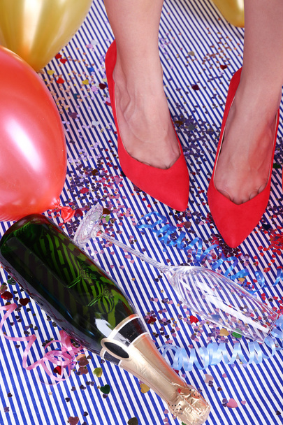 Legs with confetti, champagne and balloons on the floor - Photo, Image