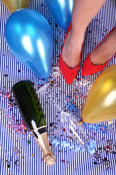Legs with confetti, champagne and balloons on the floor - Foto, Imagem